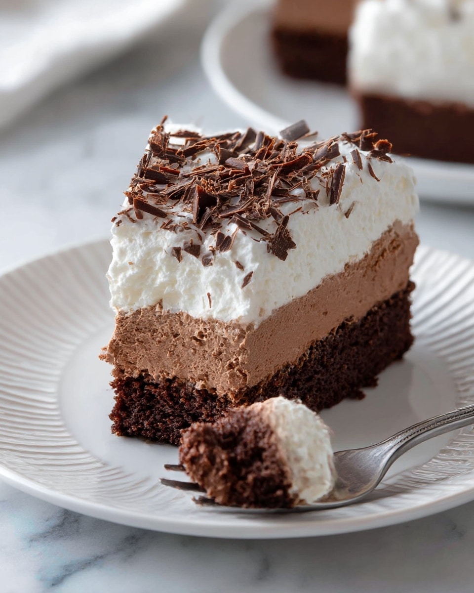 A slice of layered dessert is shown on a white plate with subtle vertical ridges, placed on a white marbled surface. The dessert has three distinct layers: the bottom layer is a dark, dense chocolate cake with a moist texture, the middle layer is a thick, light brown chocolate mousse with a smooth and airy texture, and the top layer is white whipped cream with a fluffy, soft look. The dessert is topped with uneven, dark brown chocolate shavings scattered across the surface. A silver fork in the foreground holds a bite-sized piece showing all three layers clearly. Photo taken with an iphone --ar 4:5 --v 7