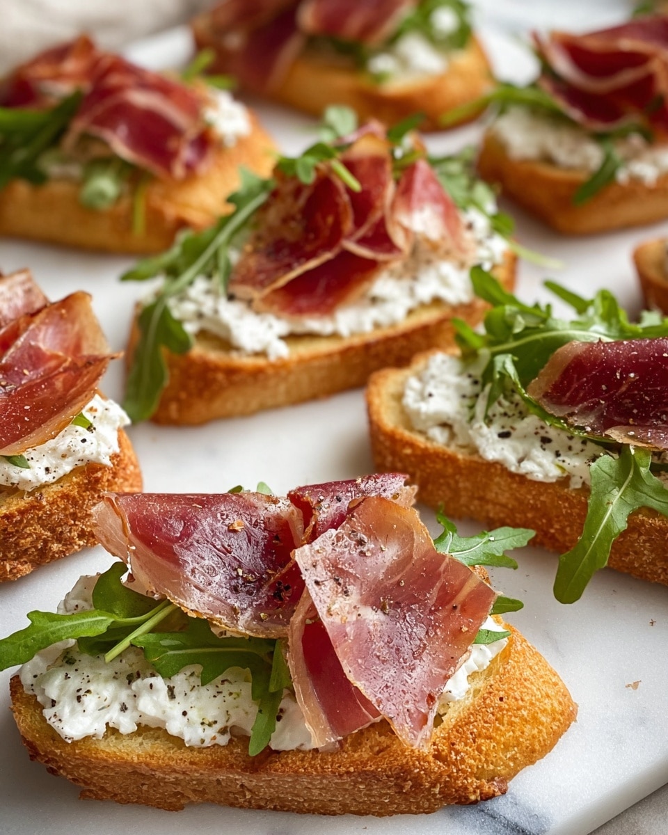 The image shows several pieces of toasted bread slices arranged on a white marbled surface. Each piece has three layers: the bottom is a golden-brown toasted bread slice with a crunchy texture, the middle layer is a thick spread of soft white cheese with a slightly crumbly texture and some black pepper sprinkled on top, and the top layer is thin slices of reddish-pink cured meat placed loosely, finished with fresh green arugula leaves that add a leafy texture. The close-up focus highlights the detailed textures and colors of the ingredients. Photo taken with an iphone --ar 4:5 --v 7