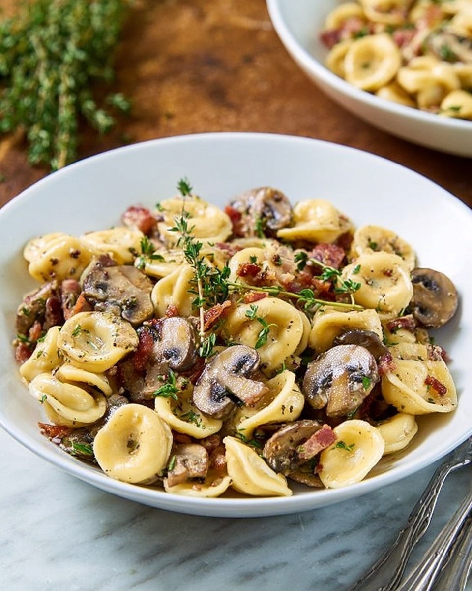 A white bowl filled with orecchiette pasta mixed with sliced mushrooms and small pieces of browned bacon, all coated in a light sauce that gives a shiny texture. The pasta is pale yellow and round-shaped, with the mushrooms appearing dark brown and soft, sitting evenly throughout. Sprigs of fresh green thyme are scattered on top, adding a touch of color and freshness. The bowl is placed on a white marbled surface, with a silver fork on the right side and blurred background showing another white bowl with more pasta. photo taken with an iphone --ar 4:5 --v 7