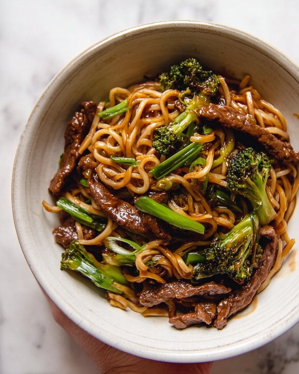 A white plate holds several round cookies, each with three visible layers: the bottom layer is a dark chocolate base covered in rough chopped nuts that form a thick border around the cookie; the middle layer is a smooth, glossy caramel disc perfectly centered; the top layer is a drizzle of milk chocolate in thin lines crossing the caramel. Some cookie crumbs and nut pieces are scattered on the white marbled surface around the plate. A glass of milk is blurred in the background, along with two more cookies. photo taken with an iphone --ar 4:5 --v 7
