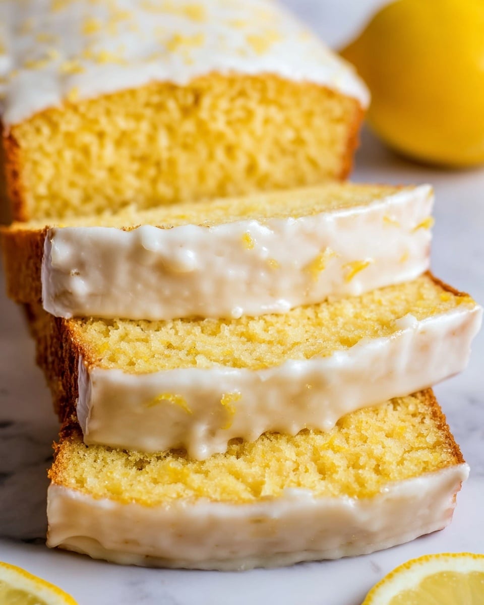 The image shows a close-up of three slices of yellow lemon cake stacked on top of each other with a visible thick white glaze layer on the top and sides of each slice. The cake has a soft, slightly crumbly texture, and the glaze looks smooth and glossy. The background is a white marbled texture with half a lemon placed to the side, complementing the lemon cake's vibrant yellow color. Photo taken with an iphone --ar 4:5 --v 7